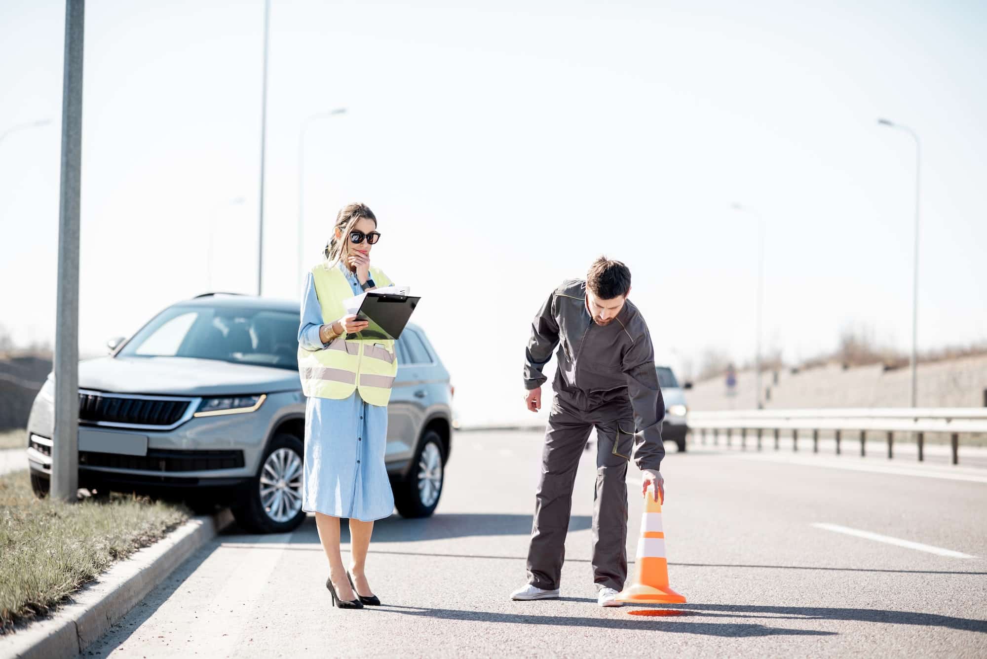 Woman and road worker during the car accident